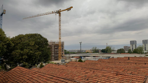 Construction site by building against sky