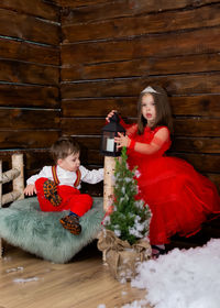 Portrait of cute girl playing with christmas tree