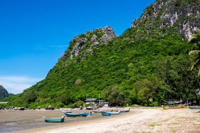 Fishing boat in the bay, mountain, and the clear blue sky