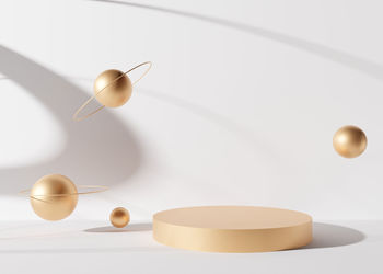 Golden round podium with spheres and shadows on white background. elegant podium for product