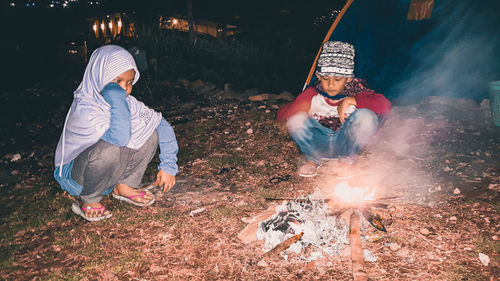 People with fire crackers at night