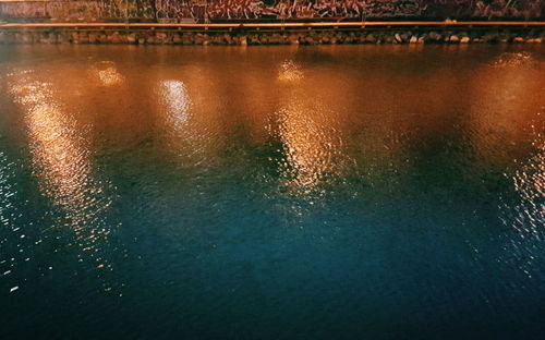 Reflection of illuminated bridge in river