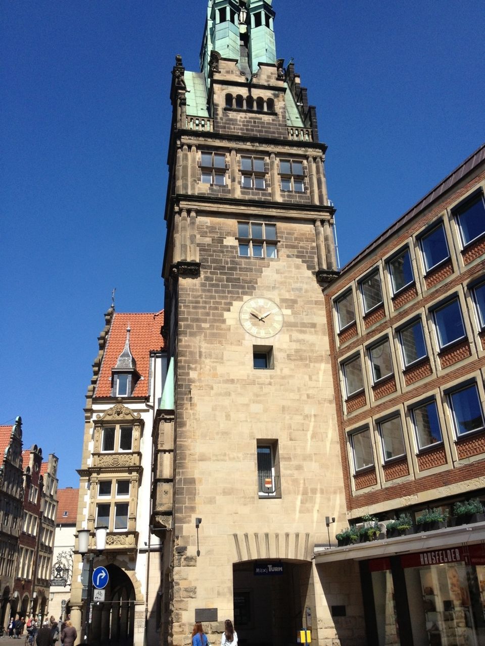 building exterior, architecture, built structure, clear sky, low angle view, city, window, blue, building, residential building, sunlight, tower, residential structure, day, city life, outdoors, travel destinations, facade, old town, shadow