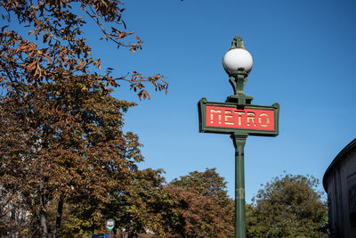 Low angle view of road sign against sky