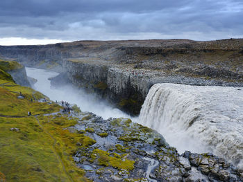 Scenic view of waterfall against sky