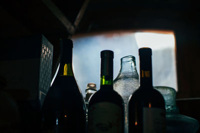 Close-up of wine bottles in darkroom