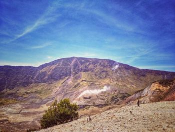 Scenic view of mountains against blue sky