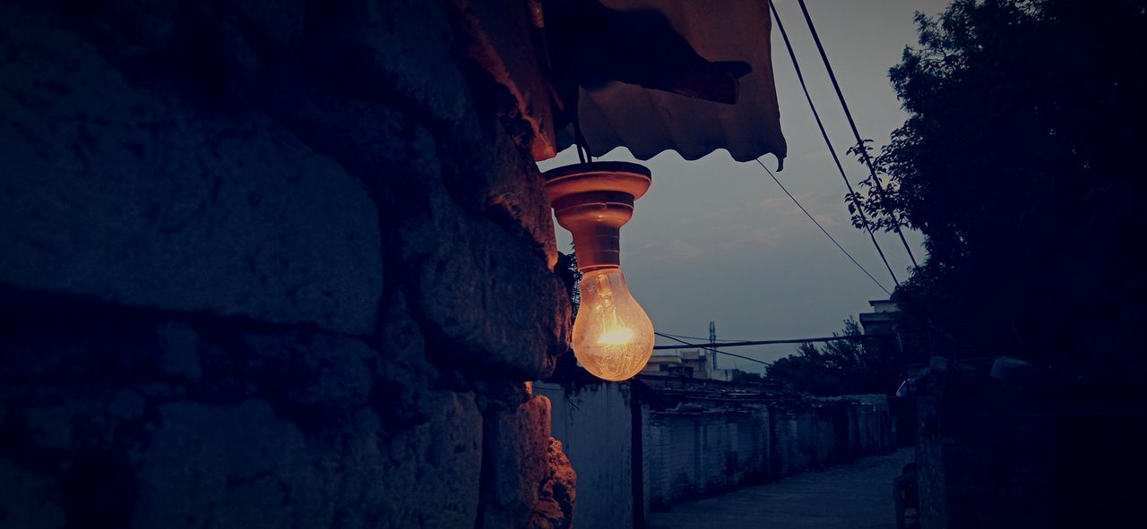 LOW ANGLE VIEW OF ILLUMINATED LANTERN HANGING ON BUILDING