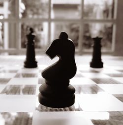 Close-up of chess pieces on table