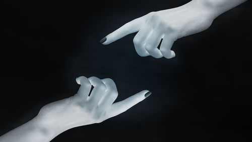 Close-up of hands over white background