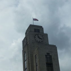 Low angle view of building against cloudy sky