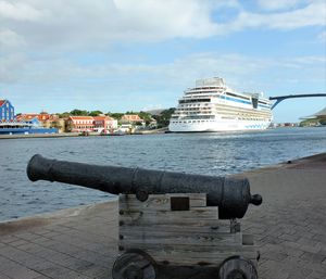 Buildings by sea against sky in city