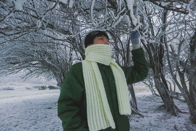 Woman standing on snow covered land