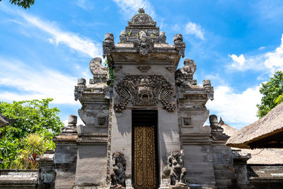 Low angle view of temple building against cloudy sky