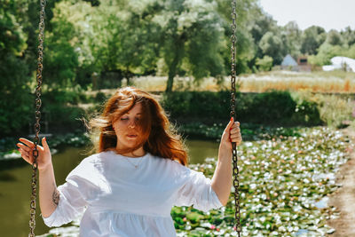 Young woman swinging at playground