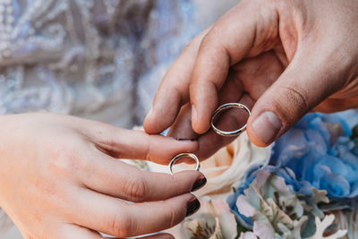 Cropped hands holding rings