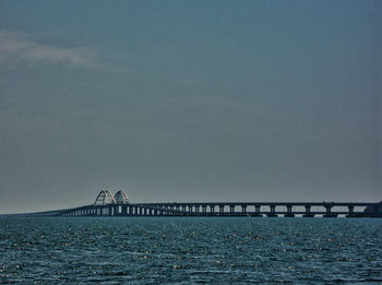 Bridge over sea against sky