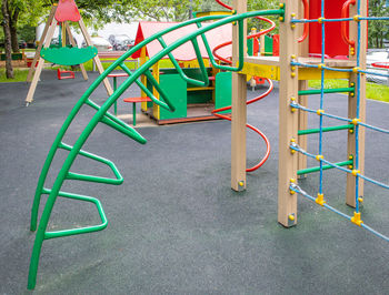 Modern children's outdoor sports play complex with slide, rope wall.