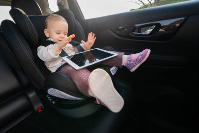 Low angle view of woman sitting in car