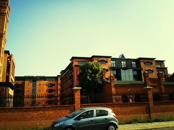 Buildings in city against clear sky