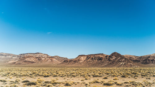 Arid mountains landscape against clear blue sky in nevada in high desert