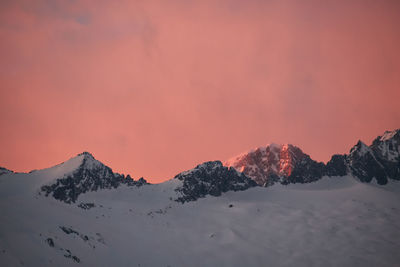 Scenic view of snowcapped mountains against sky during sunset