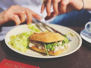 Cropped image of person having food in plate