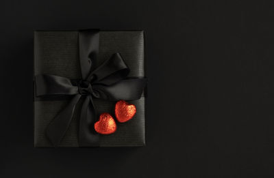 Directly above shot of gift box against black background