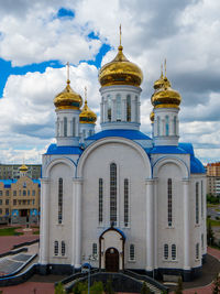 Low angle view of building against cloudy sky