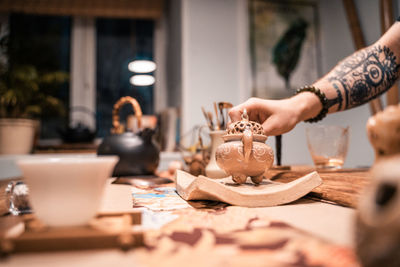 Midsection of woman preparing food on table