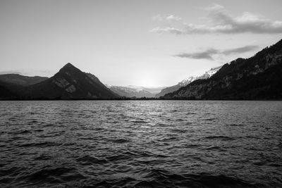 Scenic view of sea and mountains against sky