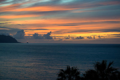 Scenic view of sea against orange sky