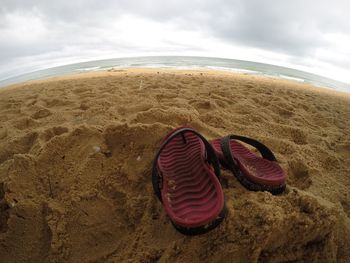 View of beach against cloudy sky