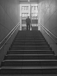 Low angle view of businessman standing by staircase