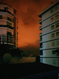 Buildings in city against sky at sunset