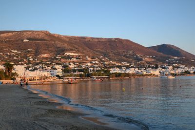 Town by sea against clear sky