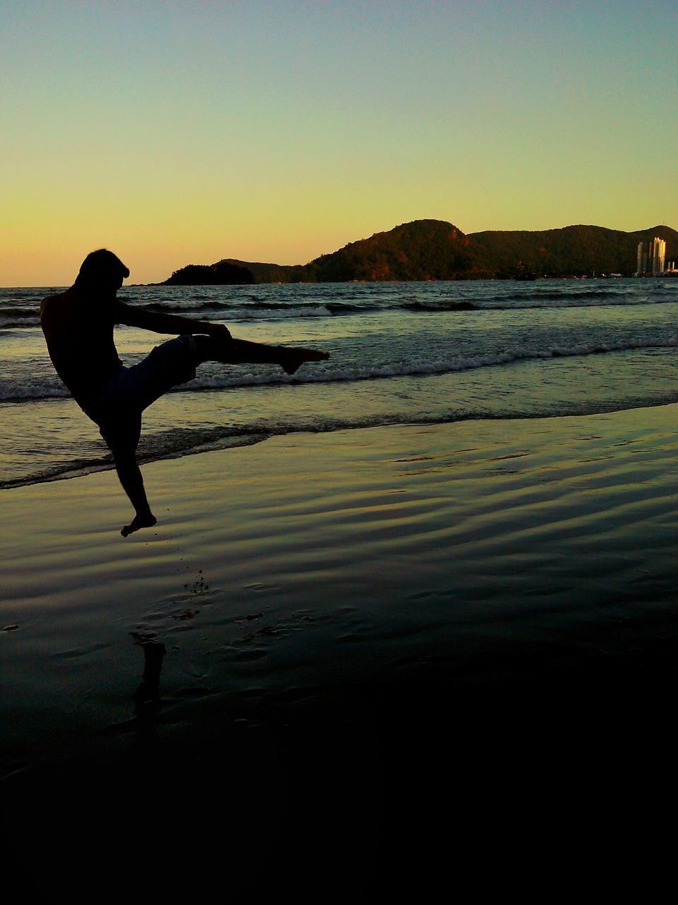 SILHOUETTE MAN ON BEACH AGAINST SKY DURING SUNSET