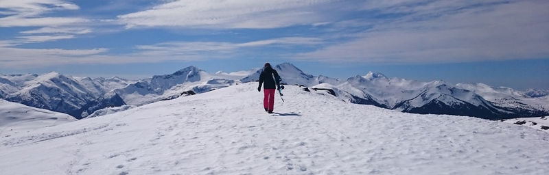 Man walking on snow covered landscape