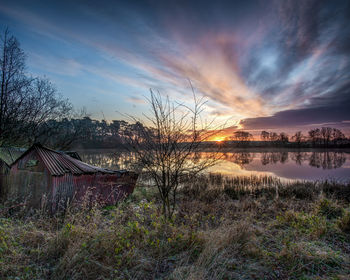 Scenic view of lake against sky during sunset