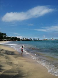 Man on beach against sky