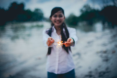 Woman holding a while standing in water