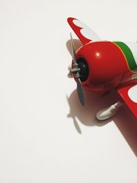 Close-up of red rose over white background