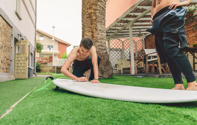 Man playing with woman in front of building