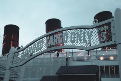 Low angle view of bridge against buildings in city