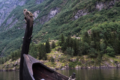 Dragon head at viking sailboat in fjord of norway