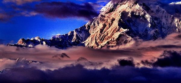 Scenic view of mountains against cloudy sky