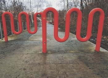 Red metal structure on footpath