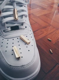 Close-up of aglets on white shoe