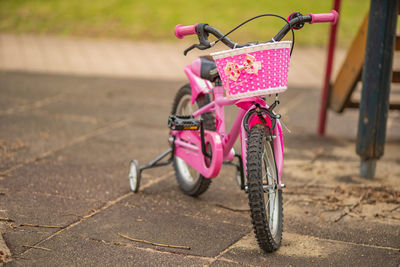 Close-up of toy bicycle on footpath