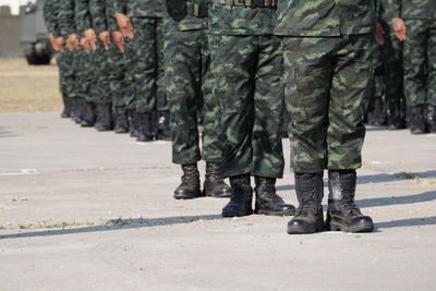 Low section of soldiers walking on street